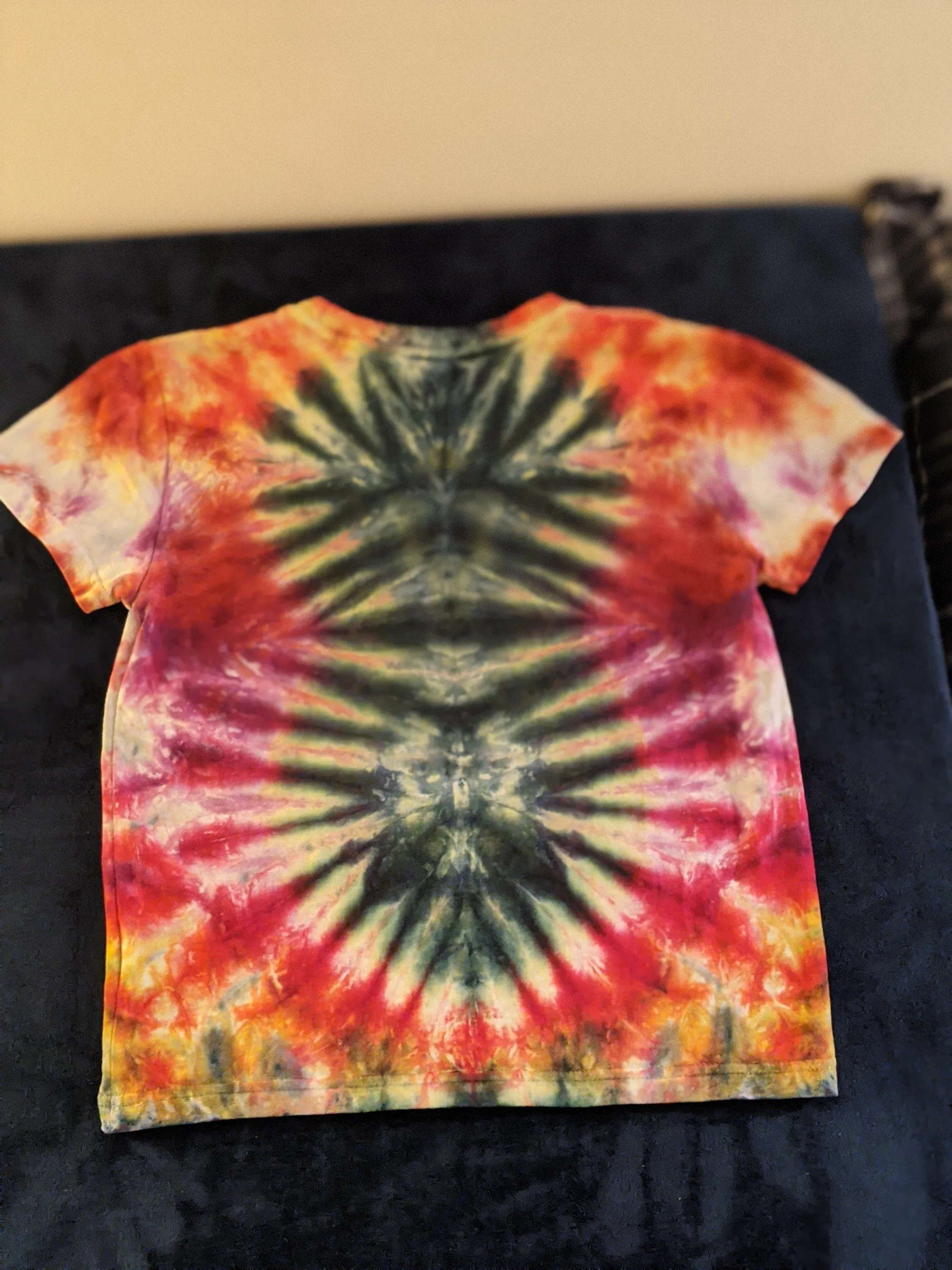 Child size 7 Hot water irrigation mandala tie dye on t-shirt.